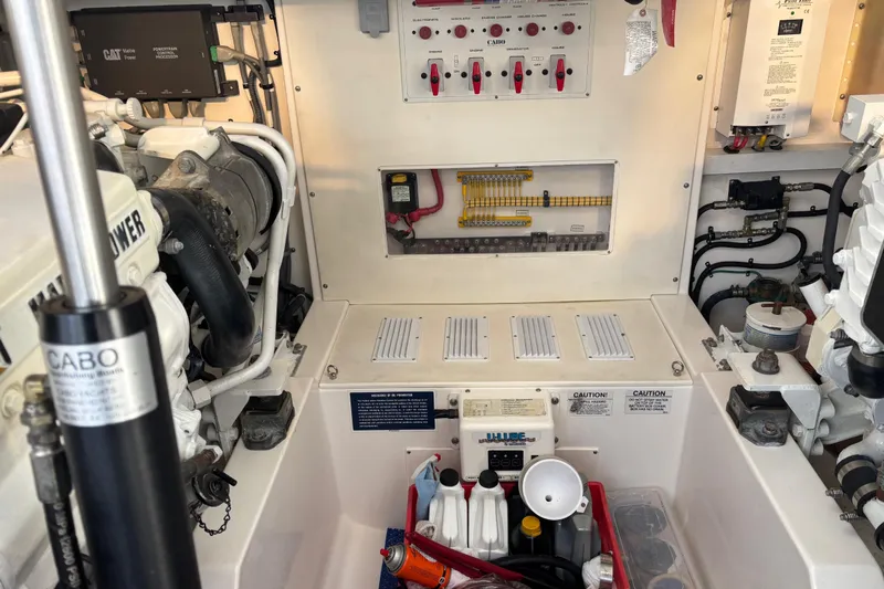  Yacht Photos Pics Engine room of 2010 Cabo 36 Express boat with control panels and equipment.
