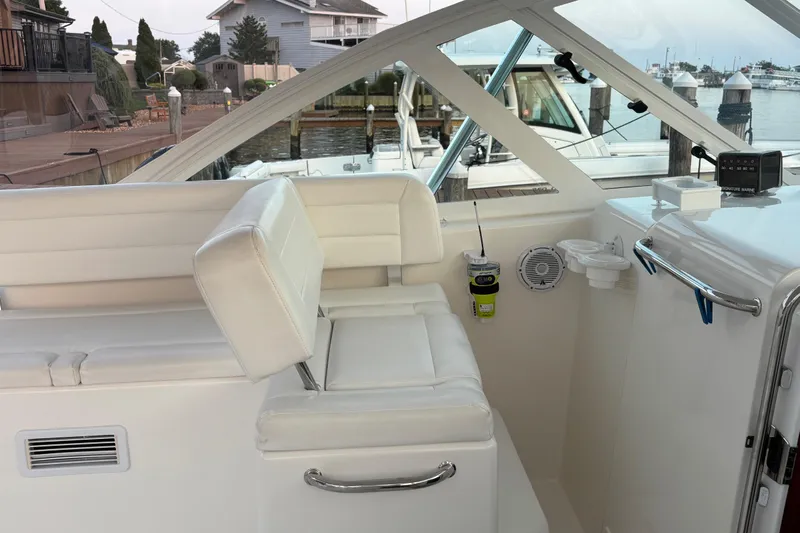  Yacht Photos Pics 2010 Cabo 36 Express boat interior with white seating and marina view.