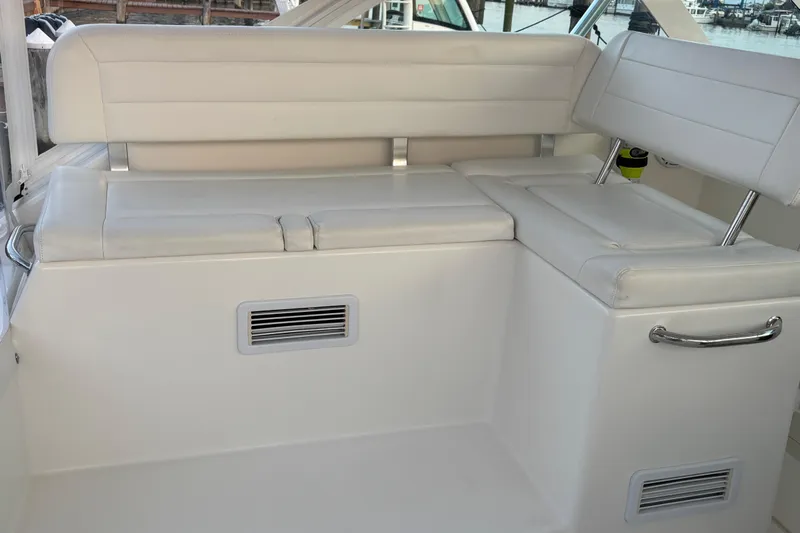  Yacht Photos Pics 2010 Cabo 36 Express boat interior seating with white cushions and metal handles.