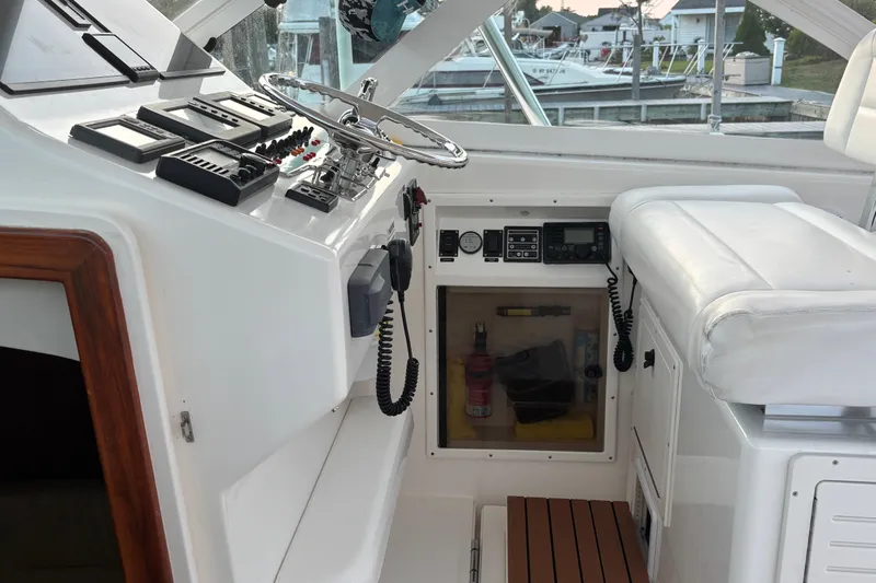  Yacht Photos Pics 2010 Cabo 36 Express boat cockpit with steering wheel and control panel.