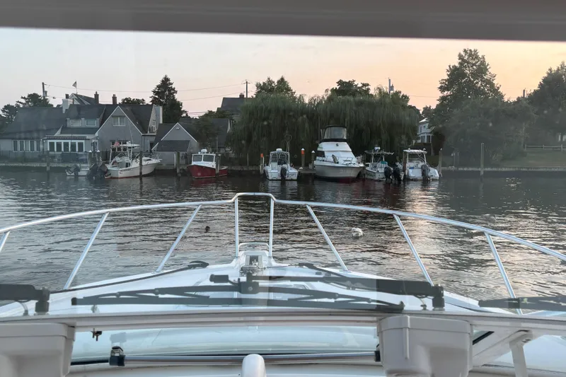  Yacht Photos Pics View from a 2010 Cabo 36 Express boat approaching a marina with docked boats.