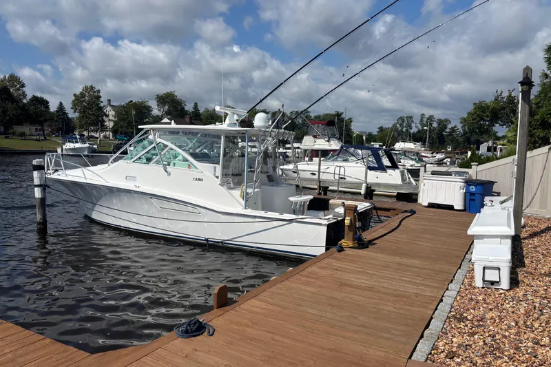  Yacht Photos Pics 2010 Cabo 36 Express boat docked at a marina under a cloudy sky.