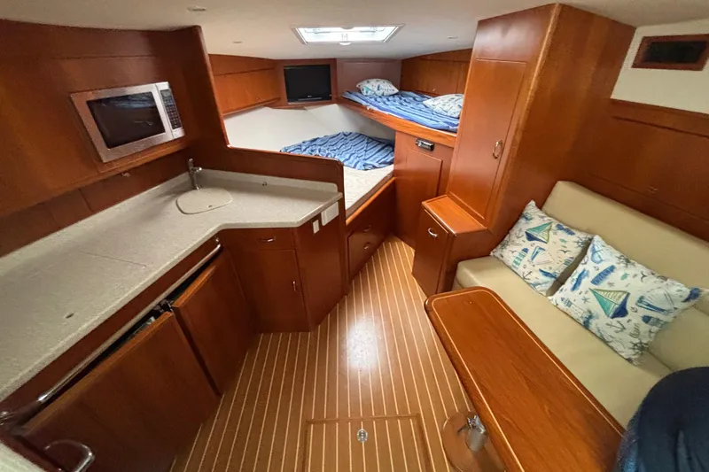  Yacht Photos Pics 2010 Cabo 36 Express yacht interior with kitchenette, bunk beds, and seating area.