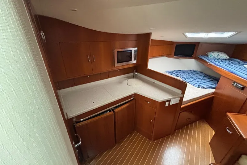  Yacht Photos Pics 2010 Cabo 36 Express interior with kitchenette and cozy sleeping area.