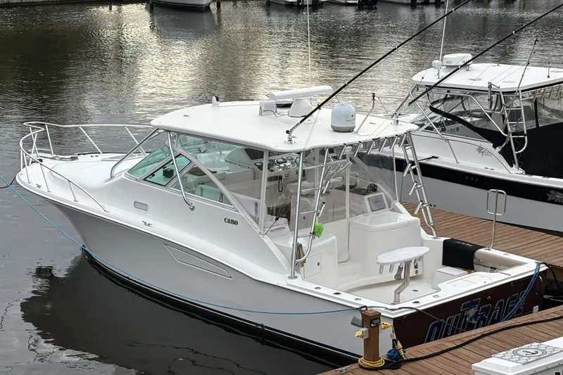  Yacht Photos Pics 2010 Cabo 36 Express boat docked at marina, featuring sleek design and fishing equipment.