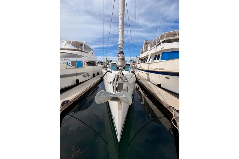 Cross Wind Yacht Photos Pics Moody Decksaloon 54 yacht docked between boats, 2016 model, under a clear blue sky.