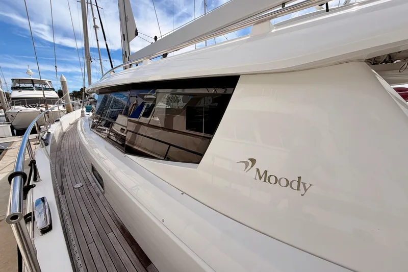 Cross Wind Yacht Photos Pics 2016 Moody Decksaloon 54 yacht docked, showcasing sleek design and wooden deck.