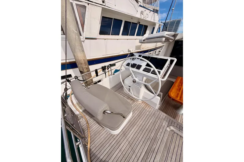 Cross Wind Yacht Photos Pics Helm of 2016 Moody Decksaloon 54 yacht with wooden deck and steering wheel.