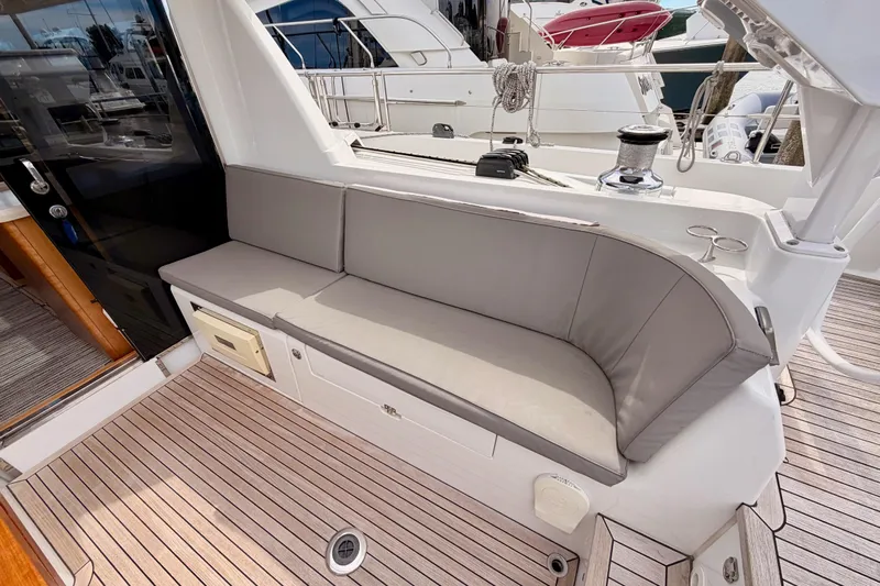 Cross Wind Yacht Photos Pics Luxurious seating area on 2016 Moody Decksaloon 54 yacht with teak flooring.