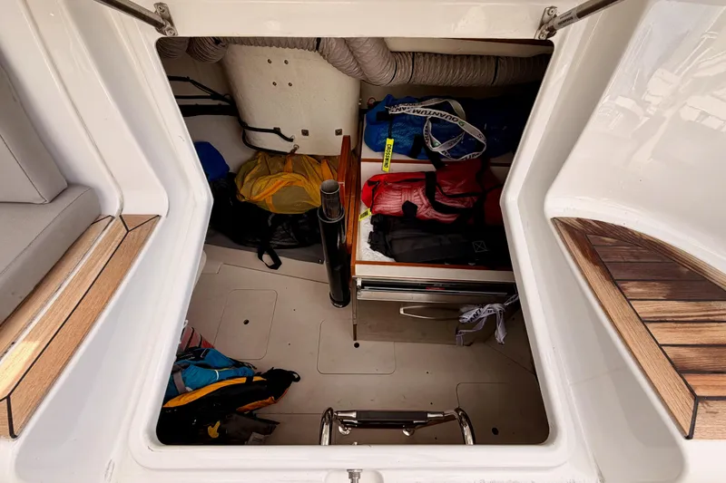 Cross Wind Yacht Photos Pics Storage compartment of 2016 Moody Decksaloon 54 yacht with various gear and equipment.