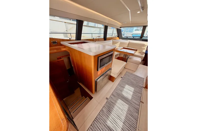 Cross Wind Yacht Photos Pics Luxurious interior of 2016 Moody Decksaloon 54 yacht with modern kitchen and seating area.