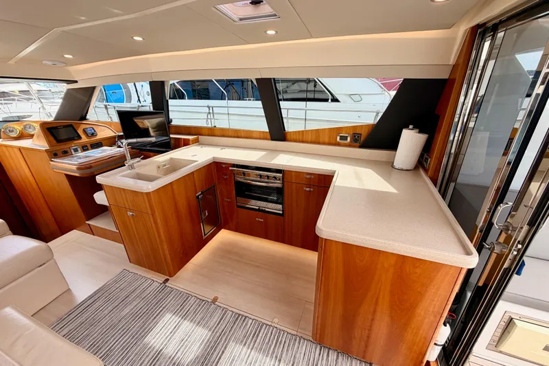 Cross Wind Yacht Photos Pics Luxurious 2016 Moody Decksaloon 54 yacht interior with modern kitchen and wooden cabinetry.