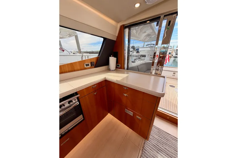 Cross Wind Yacht Photos Pics Interior of 2016 Moody Decksaloon 54 yacht with modern kitchen and marina view.
