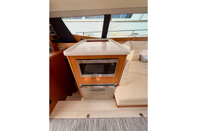 Cross Wind Yacht Photos Pics Modern kitchen area in a 2016 Moody Decksaloon 54 yacht with microwave and seating.