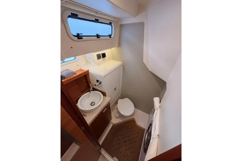 Cross Wind Yacht Photos Pics 2016 Moody Decksaloon 54 yacht bathroom with sink, toilet, and window.