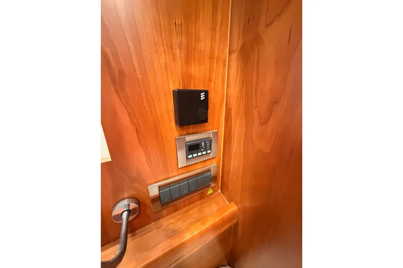 Cross Wind Yacht Photos Pics Control panel on wooden interior of 2016 Moody Decksaloon 54 yacht.