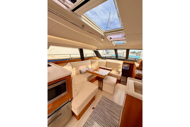 Cross Wind Yacht Photos Pics Luxurious interior of 2016 Moody Decksaloon 54 yacht with skylight and elegant seating area.