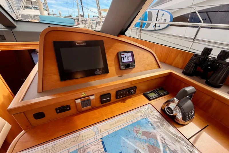 Cross Wind Yacht Photos Pics Navigation station of 2016 Moody Decksaloon 54 yacht with Raymarine equipment and nautical chart.