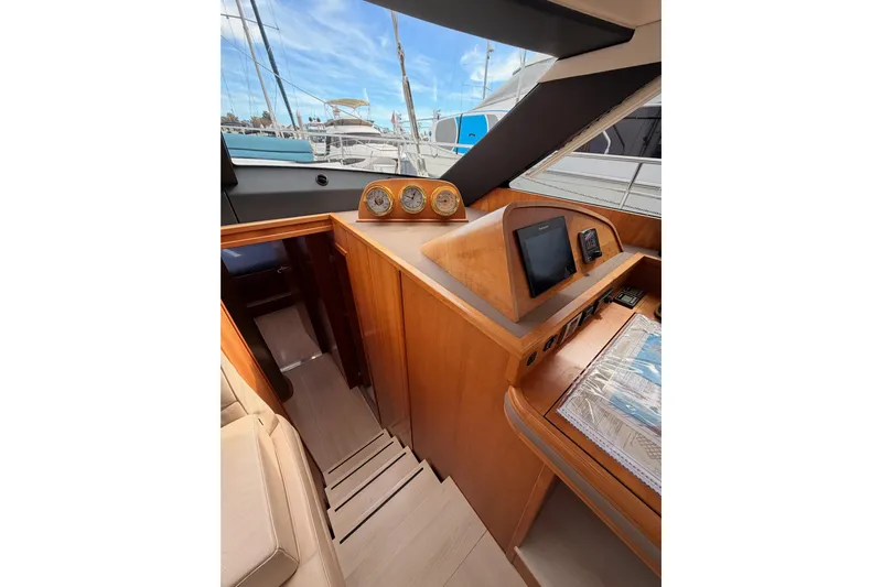 Cross Wind Yacht Photos Pics Interior of 2016 Moody Decksaloon 54 yacht with navigation instruments and wooden finish.