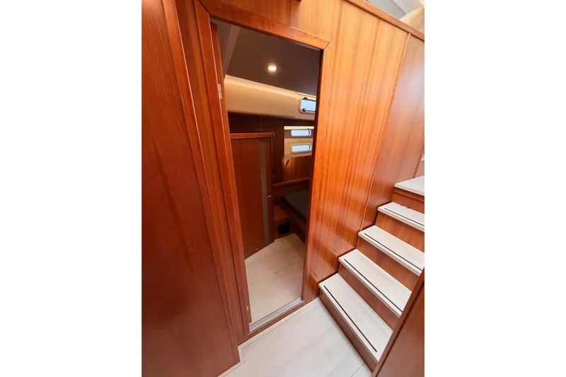 Cross Wind Yacht Photos Pics Interior of 2016 Moody Decksaloon 54 yacht with wooden paneling and stairs.