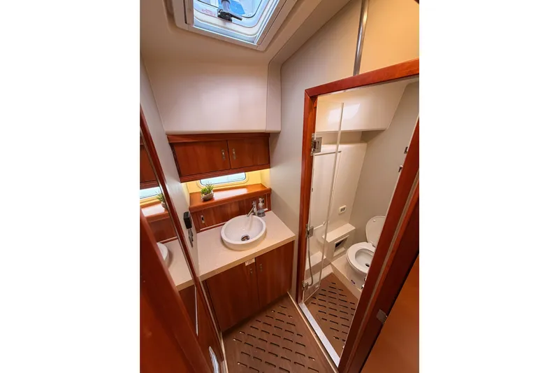 Cross Wind Yacht Photos Pics Luxurious bathroom in 2016 Moody Decksaloon 54 yacht with modern fixtures and wooden cabinetry.