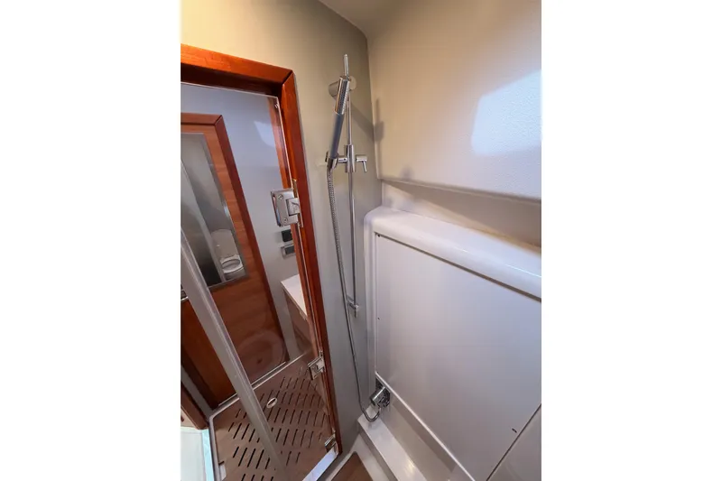 Cross Wind Yacht Photos Pics Shower area in 2016 Moody Decksaloon 54 yacht, featuring modern fixtures and wooden accents.