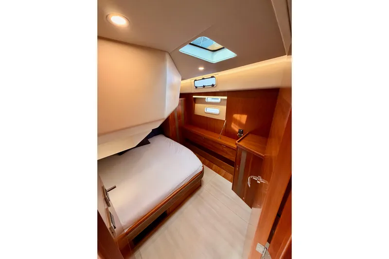 Cross Wind Yacht Photos Pics Luxurious cabin interior of 2016 Moody Decksaloon 54 yacht with skylight and wooden finish.