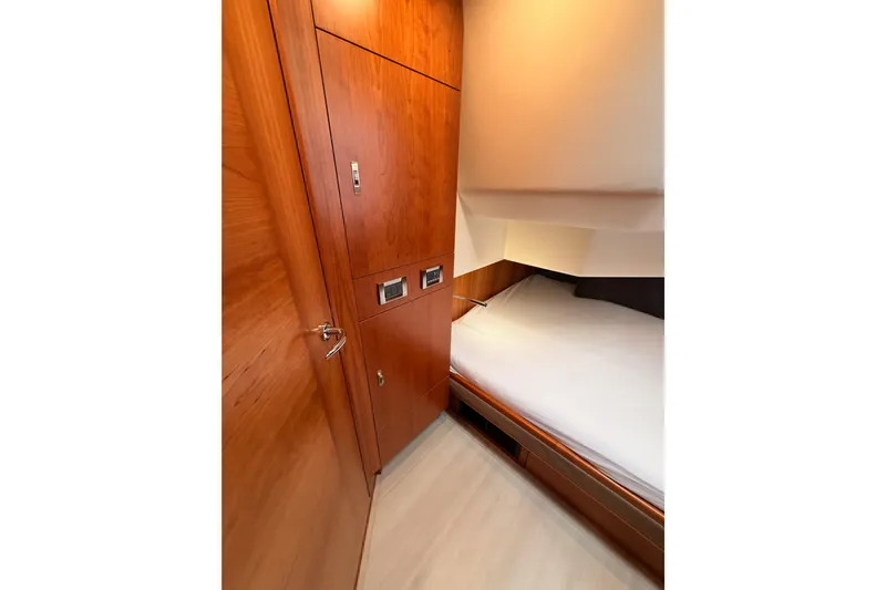 Cross Wind Yacht Photos Pics Interior cabin of 2016 Moody Decksaloon 54 yacht with wooden finish and cozy bed.