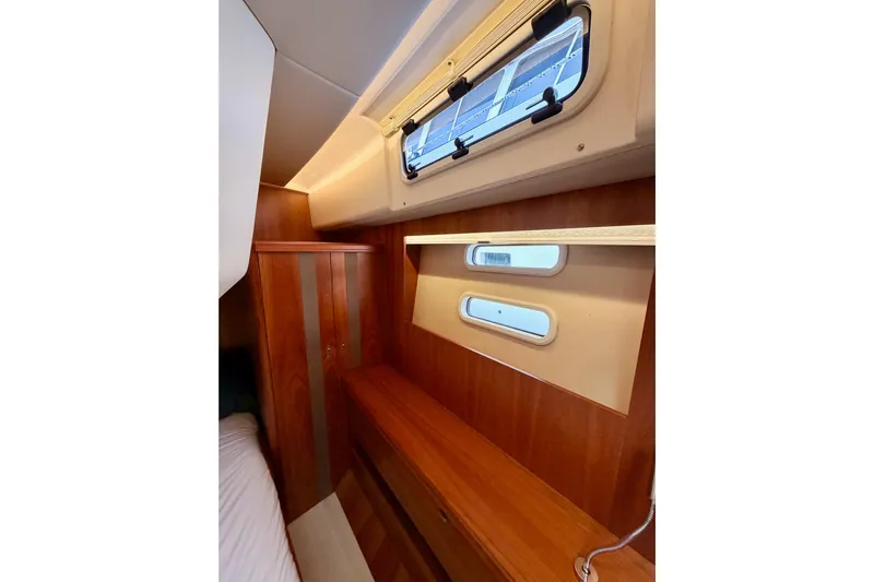 Cross Wind Yacht Photos Pics Interior cabin of 2016 Moody Decksaloon 54 yacht with wooden finish and porthole windows.