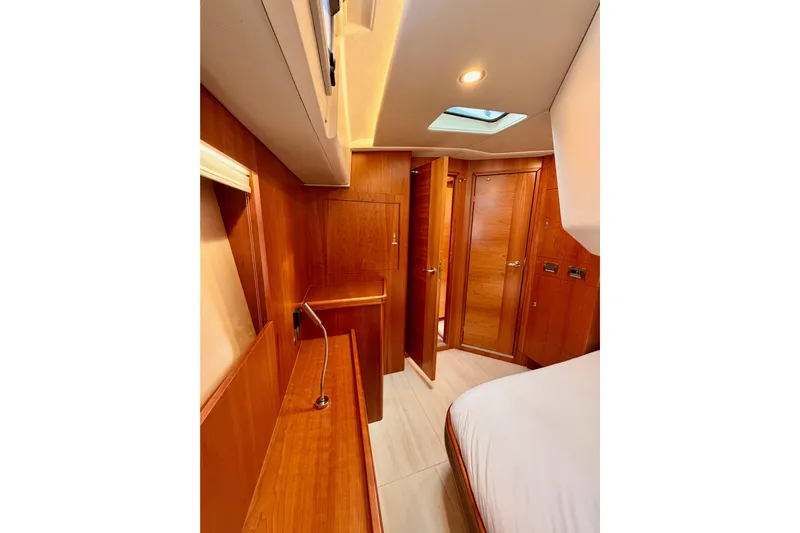 Cross Wind Yacht Photos Pics Luxurious interior of 2016 Moody Decksaloon 54 yacht with wooden finishes and modern lighting.