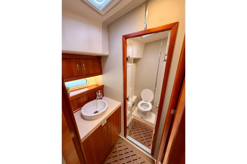 Cross Wind Yacht Photos Pics Luxurious bathroom in 2016 Moody Decksaloon 54 yacht with modern fixtures and wooden accents.