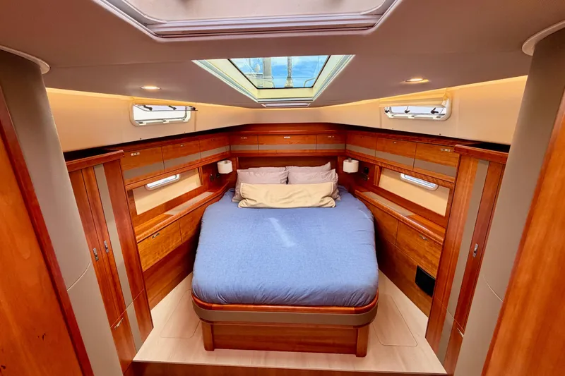 Cross Wind Yacht Photos Pics Luxurious cabin interior of 2016 Moody Decksaloon 54 yacht with skylight and wood finish.