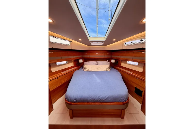Cross Wind Yacht Photos Pics Luxurious cabin interior of 2016 Moody Decksaloon 54 yacht with skylight and wooden finish.