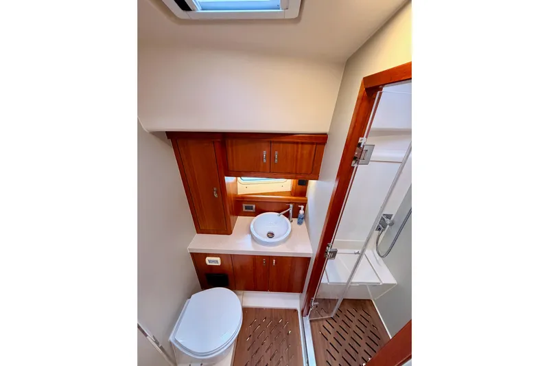 Cross Wind Yacht Photos Pics Luxurious bathroom in 2016 Moody Decksaloon 54 yacht with wood accents and modern fixtures.