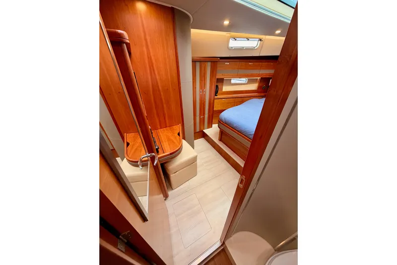 Cross Wind Yacht Photos Pics Luxurious interior of 2016 Moody Decksaloon 54 yacht with wood finish and cozy bedroom.
