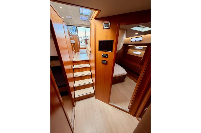 Cross Wind Yacht Photos Pics Interior of 2016 Moody Decksaloon 54 yacht with wooden stairs and cozy cabin.