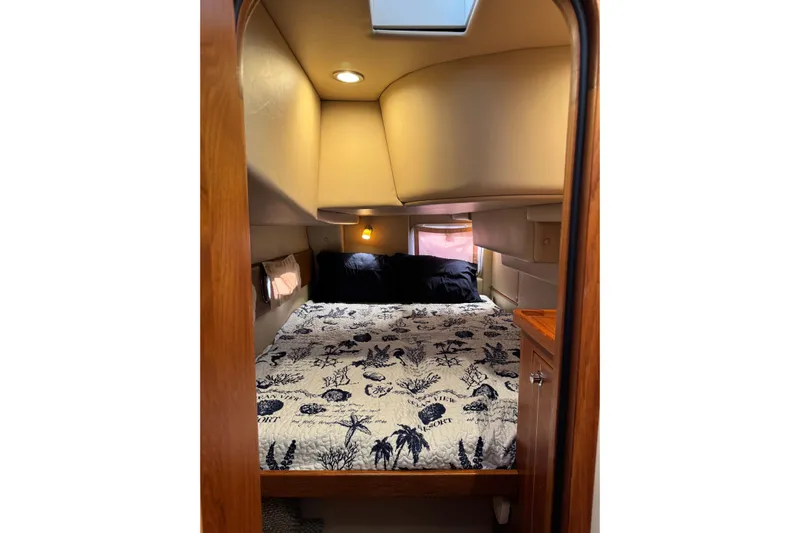 Vita Nova Yacht Photos Pics Cozy cabin interior of 2018 Aspen C120 boat with nautical-themed bedding.