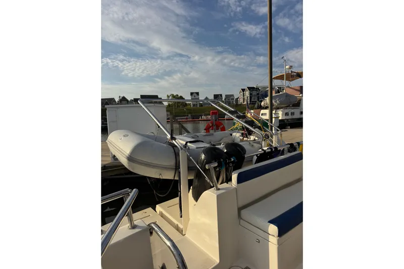 Vita Nova Yacht Photos Pics 2018 Aspen C120 boat docked with inflatable dinghy and scenic marina view.