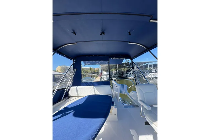 Vita Nova Yacht Photos Pics Interior view of 2018 Aspen C120 boat with blue canopy and seating.
