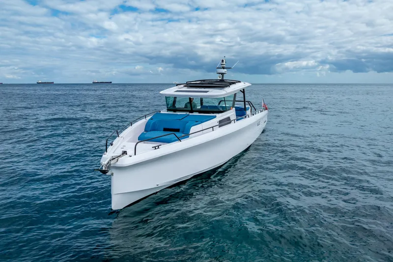  Yacht Photos Pics 2025 Axopar 45 Cross Top boat on open sea under cloudy sky.
