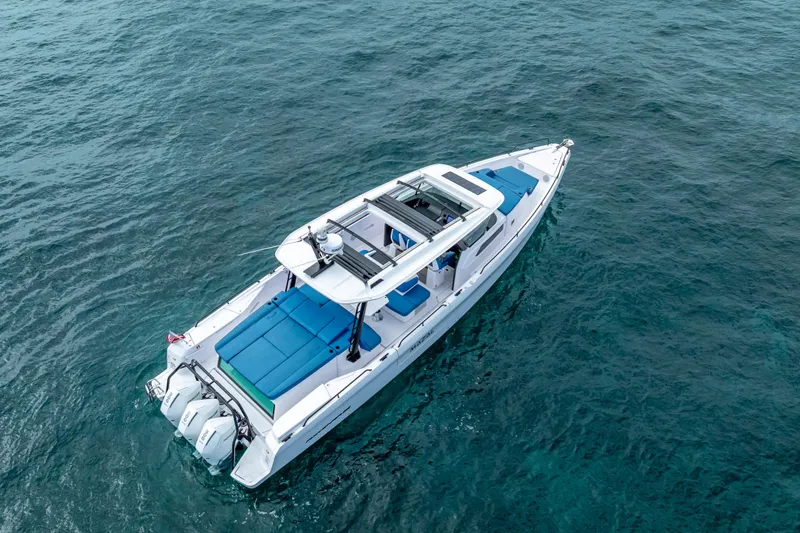  Yacht Photos Pics 2025 Axopar 45 Cross Top boat cruising on clear blue water.