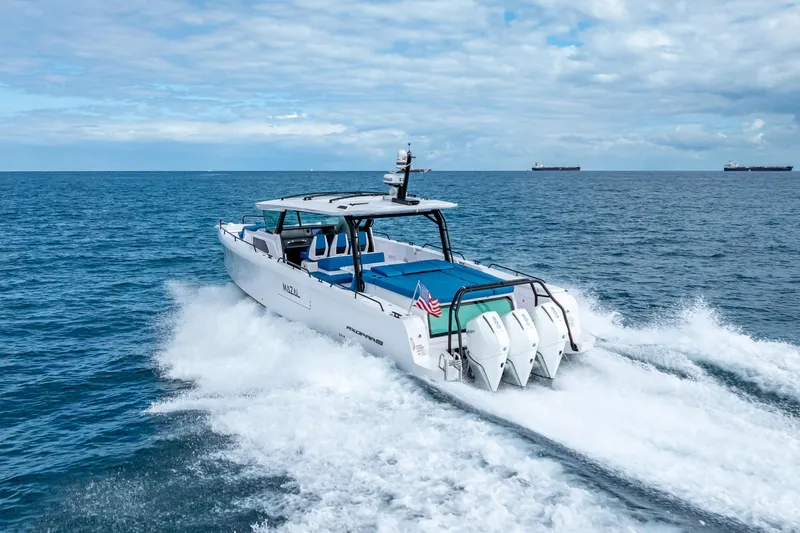  Yacht Photos Pics 2025 Axopar 45 Cross Top cruising on open sea with triple engines.