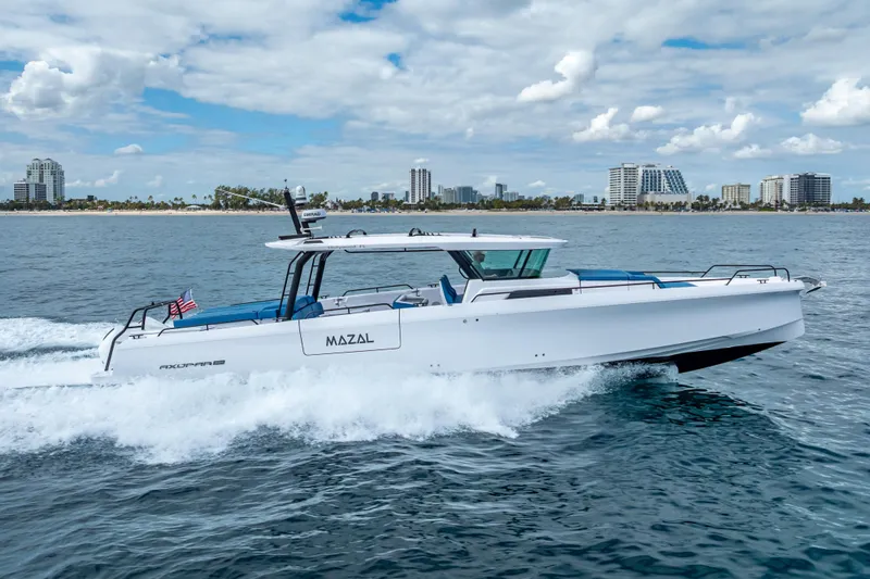  Yacht Photos Pics 2025 Axopar 45 Cross Top cruising on ocean near city skyline.