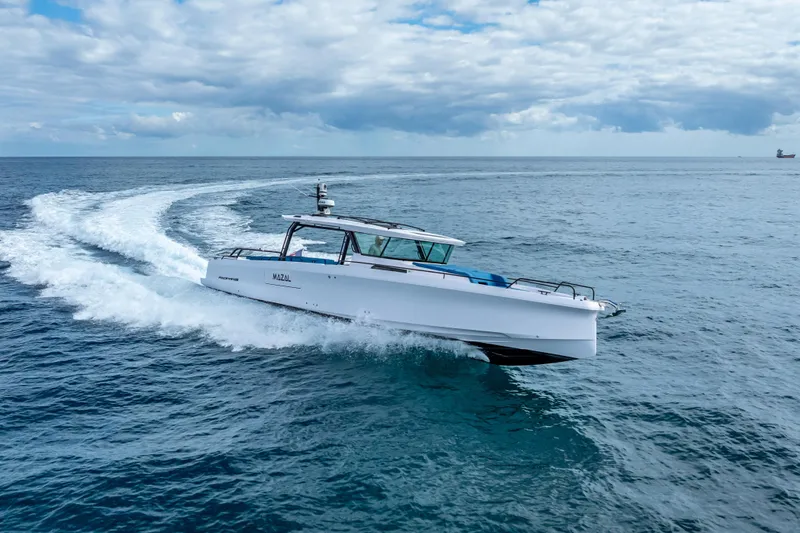  Yacht Photos Pics 2025 Axopar 45 Cross Top cruising on open sea under cloudy sky.