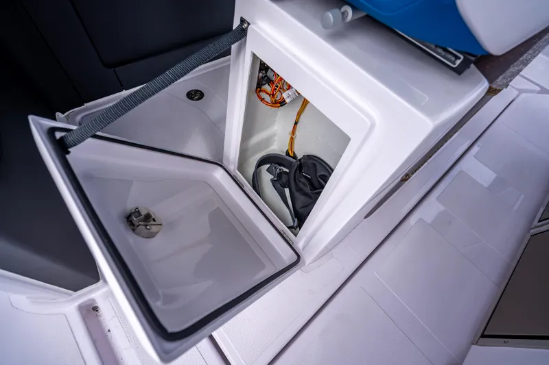  Yacht Photos Pics 2025 Axopar 45 Cross Top storage compartment with open hatch, showcasing interior details.