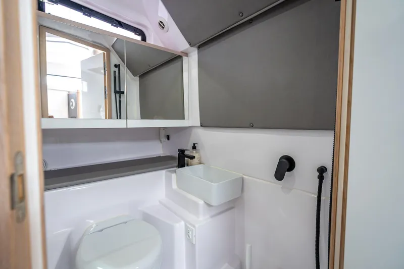 Yacht Photos Pics Modern bathroom interior of 2025 Axopar 45 Cross Top boat, featuring sleek fixtures and compact design.