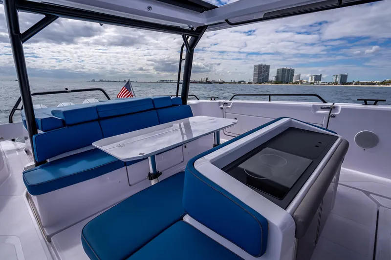  Yacht Photos Pics 2025 Axopar 45 Cross Top boat interior with blue seating and ocean view.