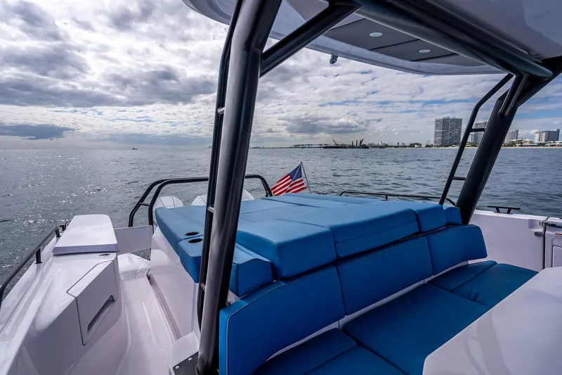  Yacht Photos Pics 2025 Axopar 45 Cross Top boat with blue seating, cruising on open water.