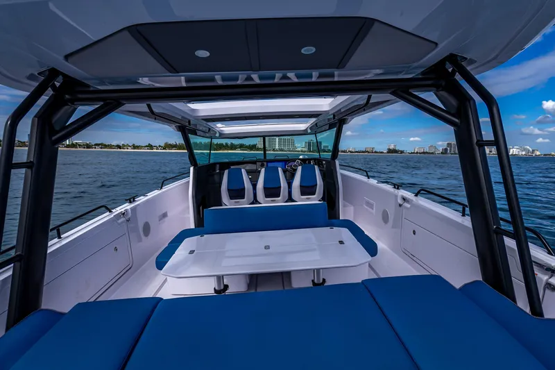  Yacht Photos Pics 2025 Axopar 45 Cross Top boat interior with blue seating and ocean view.