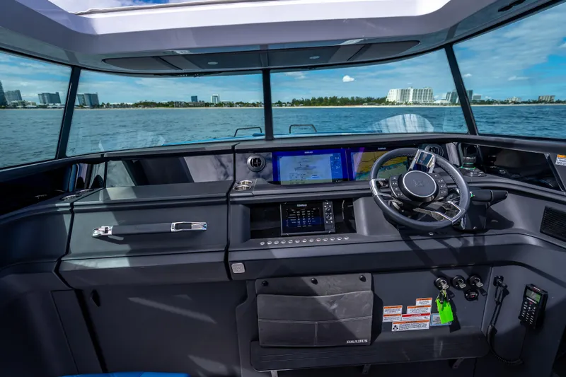  Yacht Photos Pics Helm of 2025 Axopar 45 Cross Top boat with modern navigation system.